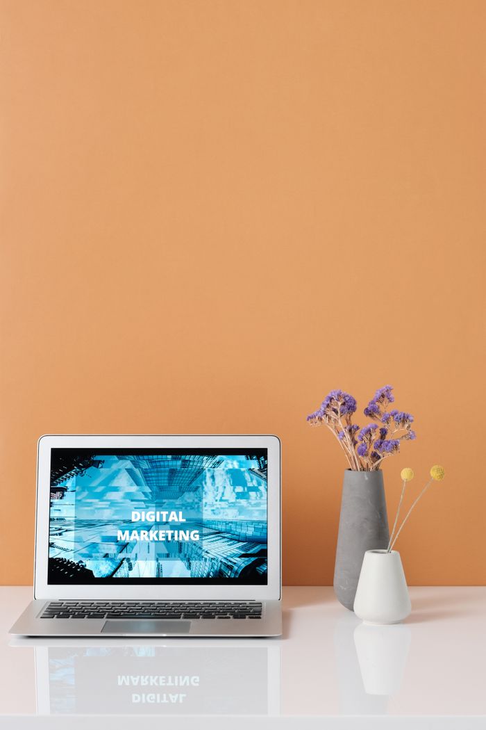 home-services-02 Modern workspace with laptop and decorative flowers showcasing digital marketing.
